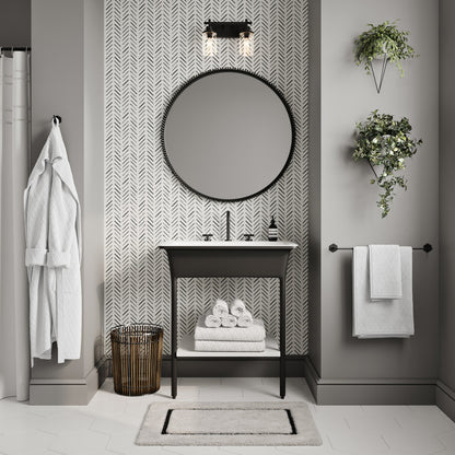 Brusque 21-inch matte black towel bar mounted on gray wall with white towel hanging.