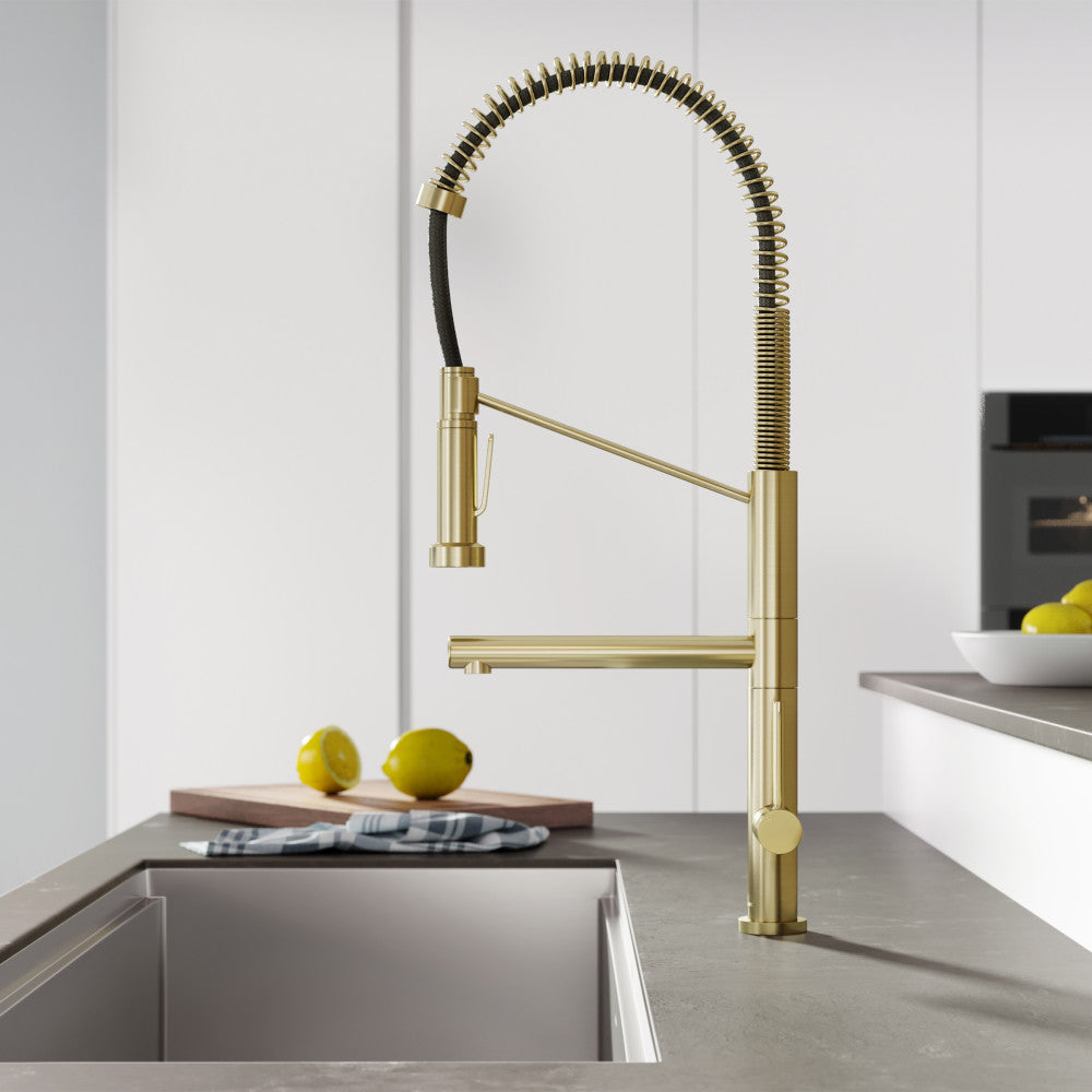 Single handle pull-down kitchen faucet with pot filler in brushed gold finish.